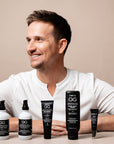 Man sitting with OG hair care products on a beige background