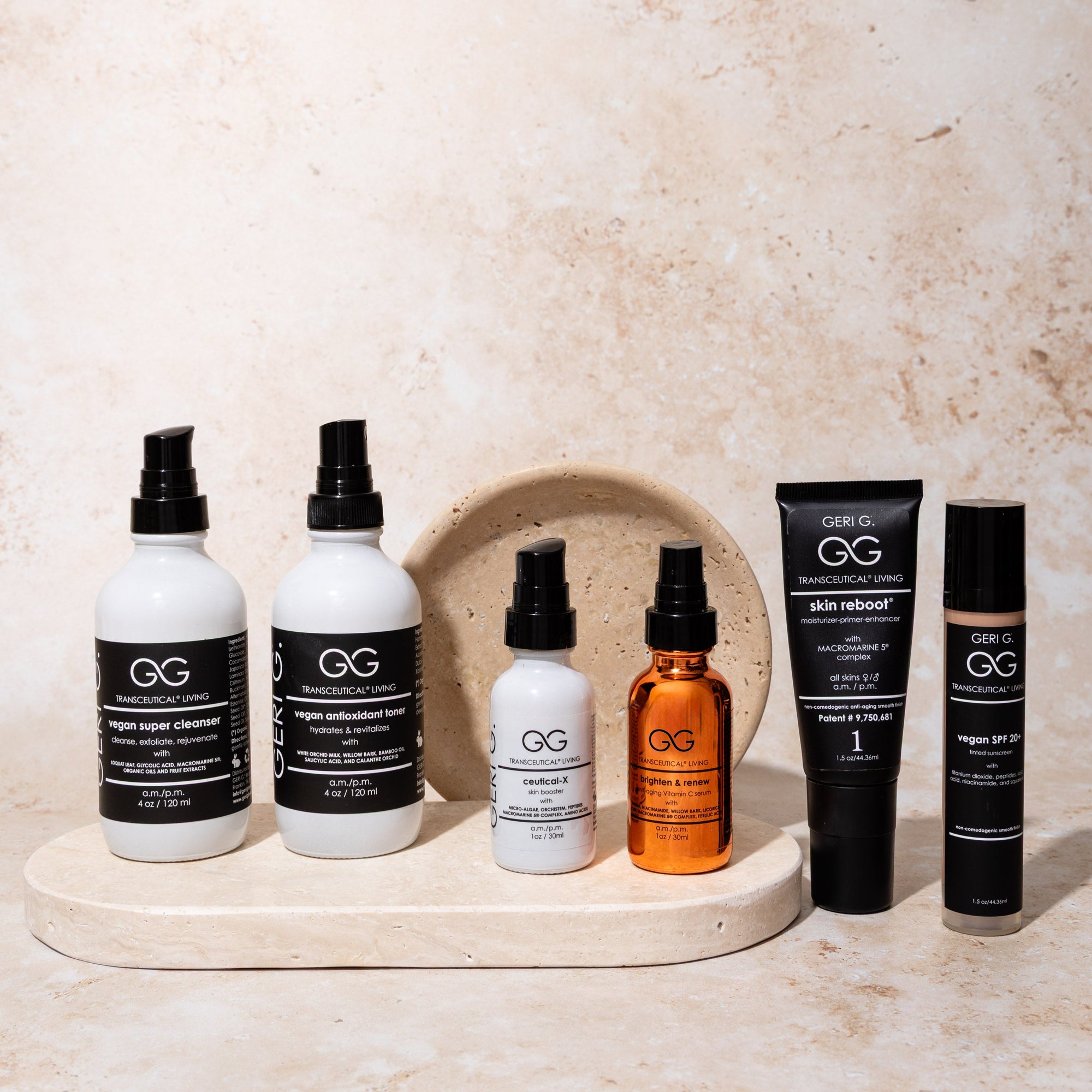 Collection of Geri G. skincare products on a marble tray with a beige background