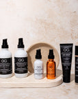 Collection of Geri G. skincare products on a marble tray with a beige background